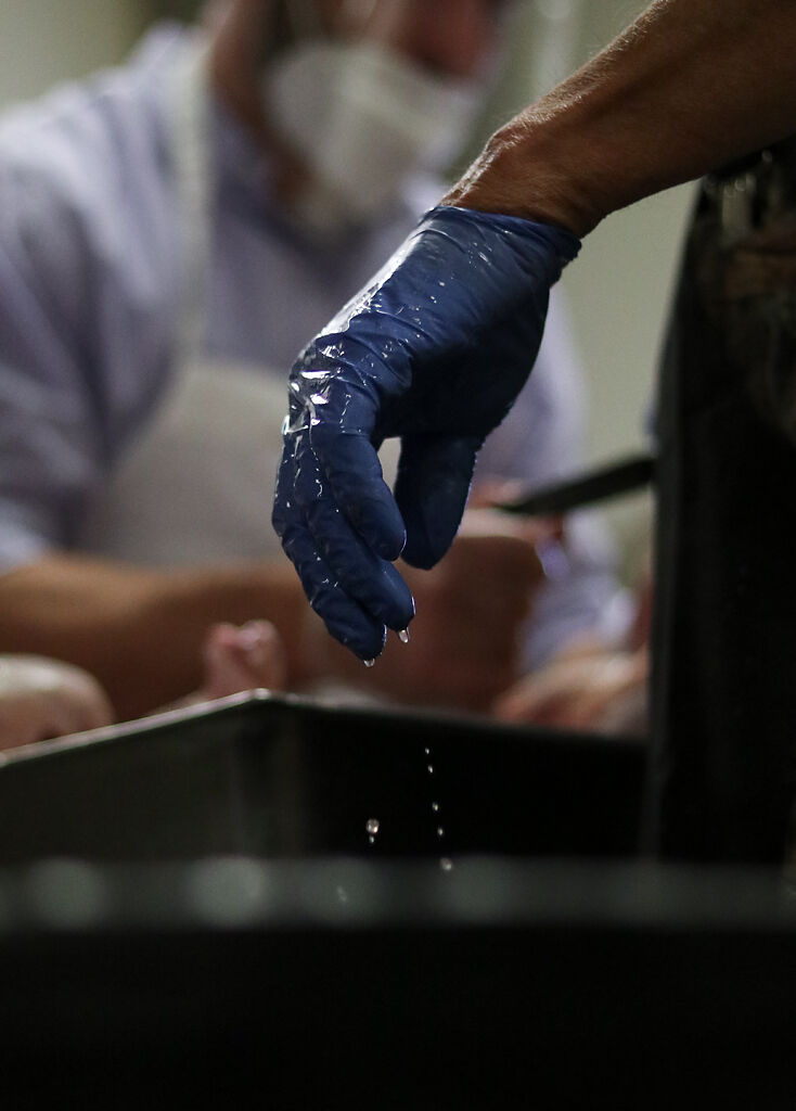 Bobby Pezold's hand drips with turkey juice